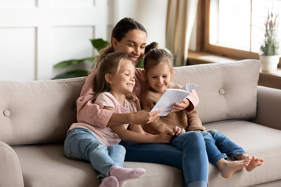 Mom reading with her kids on the couch